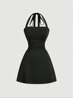 Women's sleeveless polka dot short dress with halter neckline and gathered back