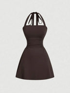 Women's sleeveless polka dot short dress with halter neckline and gathered back