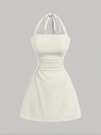 Women's sleeveless polka dot short dress with halter neckline and gathered back